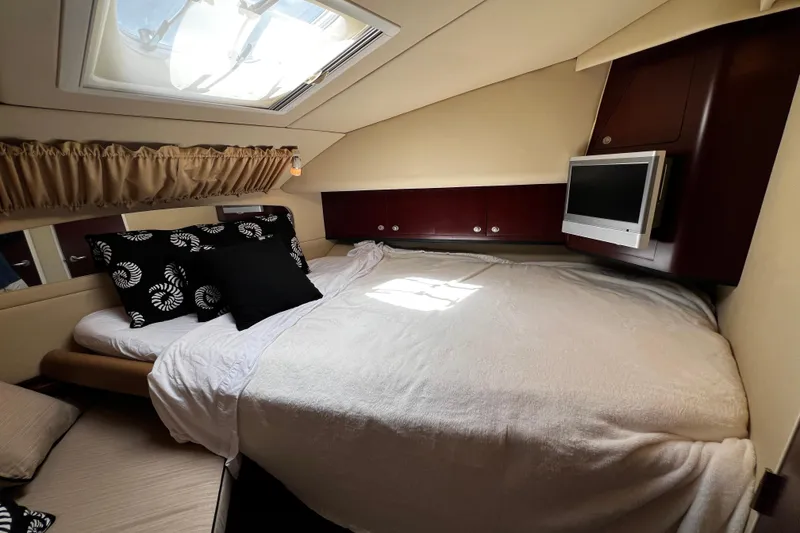 Slide: The Image of Luxurious 2006 Sea Ray 40 Motor Yacht bedroom with skylight and TV. - 37