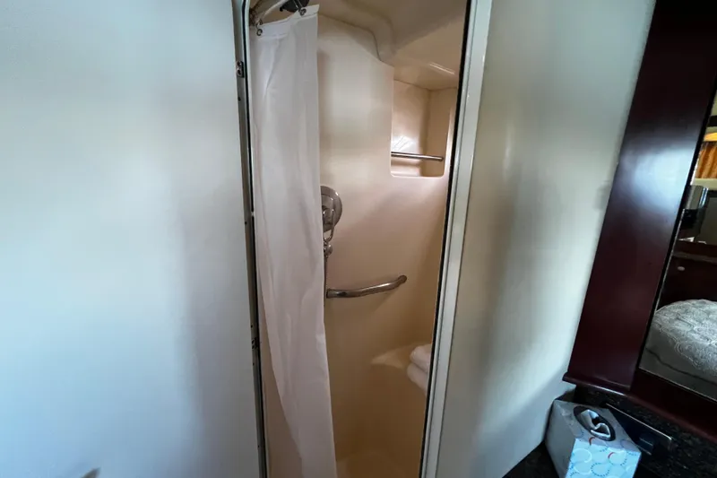 Slide: The Image of Shower area in 2006 Sea Ray 40 Motor Yacht, featuring curtain and towel rack. - 45