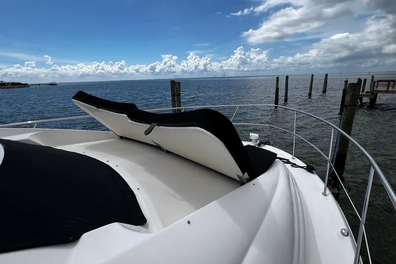 Slide: The Image of 2006 Sea Ray 40 Motor Yacht with sun loungers on deck, overlooking serene ocean view. - 49