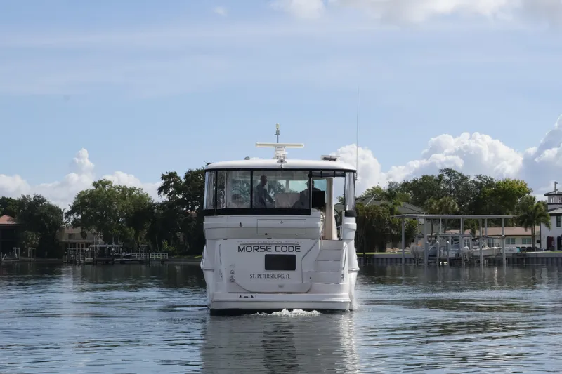 Slide: The Image of 2006 Sea Ray 40 Motor Yacht cruising on calm waters, rear view. - 4