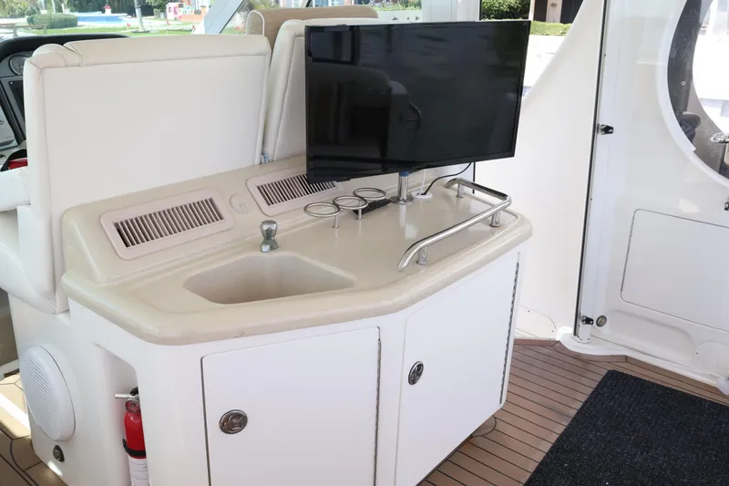 Slide: The Image of 2006 Sea Ray 40 Motor Yacht interior with sink, TV, and storage cabinets. - 18