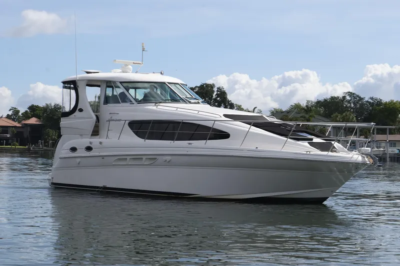 Slide: The Image of 2006 Sea Ray 40 Motor Yacht on calm water, showcasing sleek design and luxury features. - 1