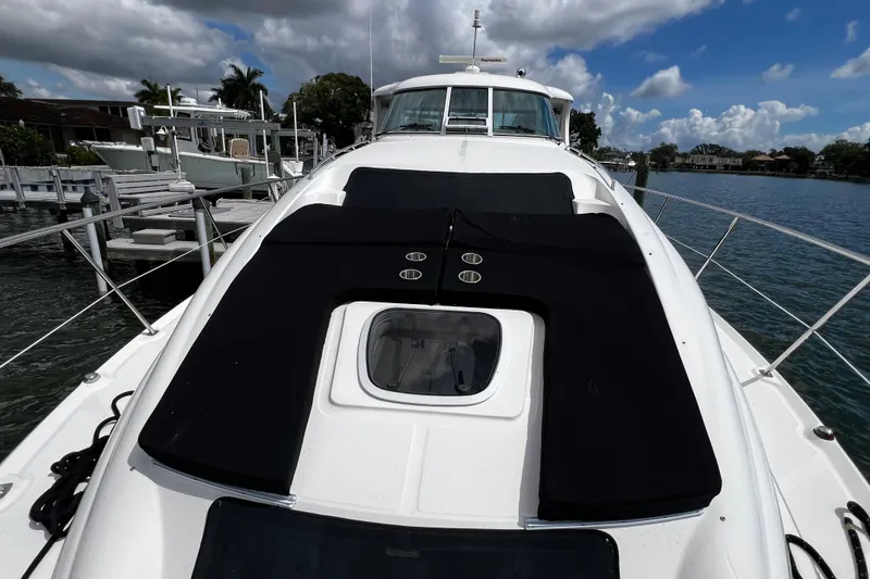 Slide: The Image of 2006 Sea Ray 40 Motor Yacht on calm water, featuring spacious deck and sleek design. - 51