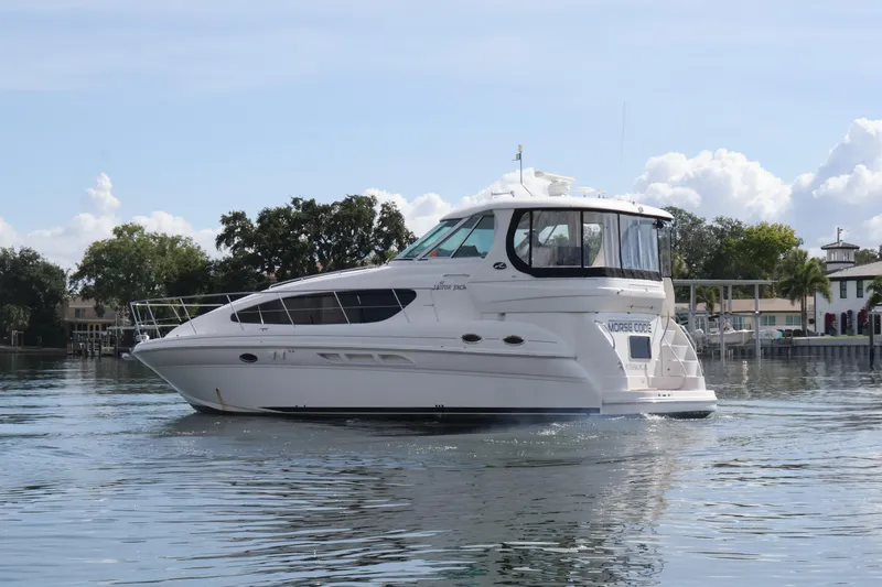 Slide: The Image of 2006 Sea Ray 40 Motor Yacht cruising on calm waters under a clear sky. - 5