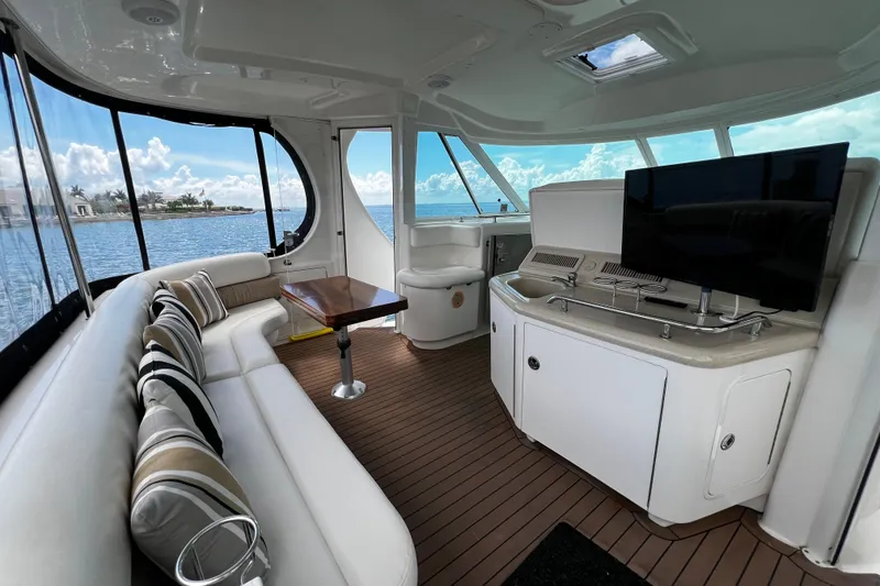 Slide: The Image of Luxurious interior of 2006 Sea Ray 40 Motor Yacht with seating, TV, and ocean view. - 9