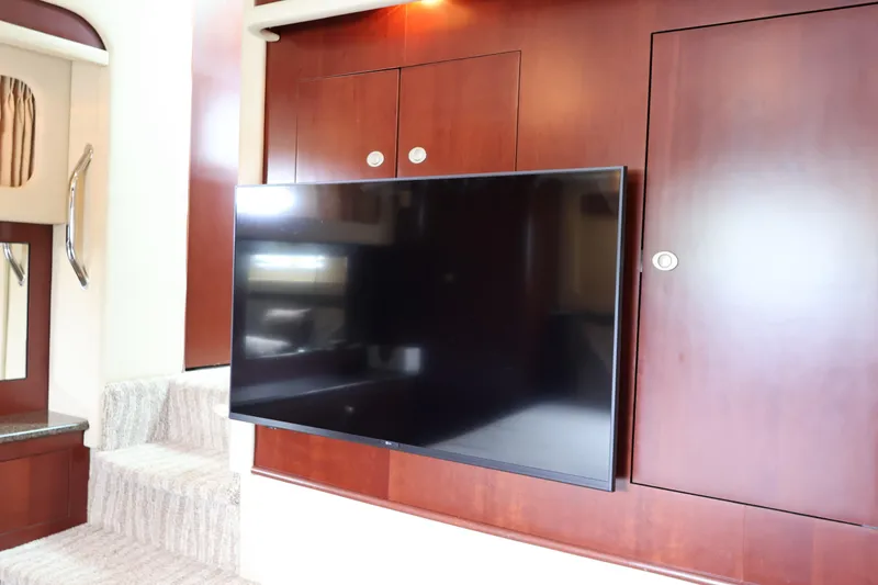 Slide: The Image of Interior of 2006 Sea Ray 40 Motor Yacht with mounted TV and wooden cabinetry. - 46