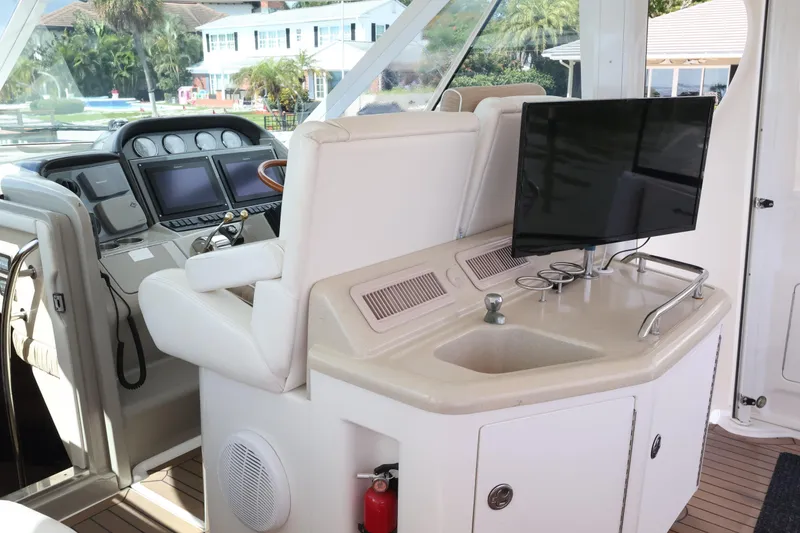 Slide: The Image of 2006 Sea Ray 40 Motor Yacht helm with modern controls and entertainment setup. - 17