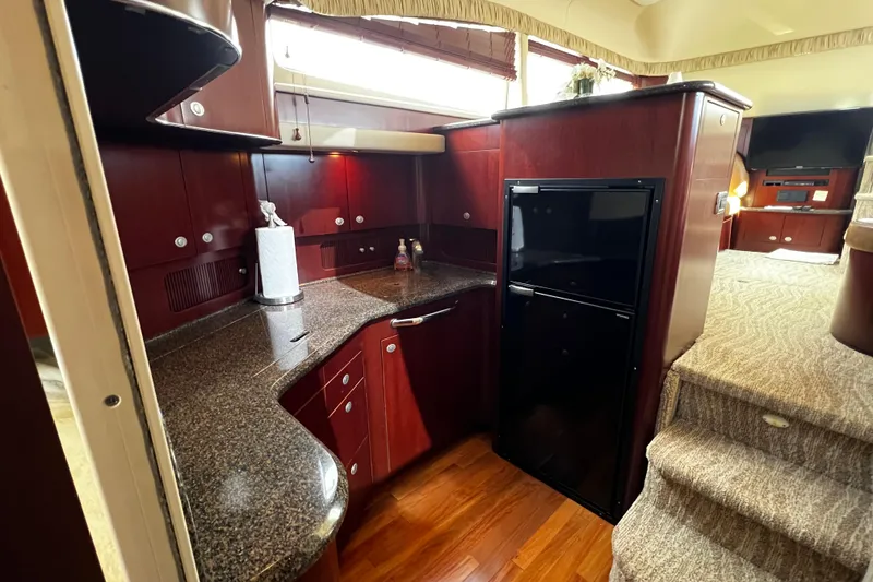 Slide: The Image of Luxurious 2006 Sea Ray 40 Motor Yacht interior with elegant wood cabinetry and modern appliances. - 34