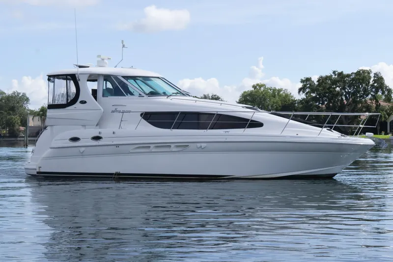 The Image of 2006 Sea Ray 40 Motor Yacht on calm water, showcasing sleek design and luxury features. - 0