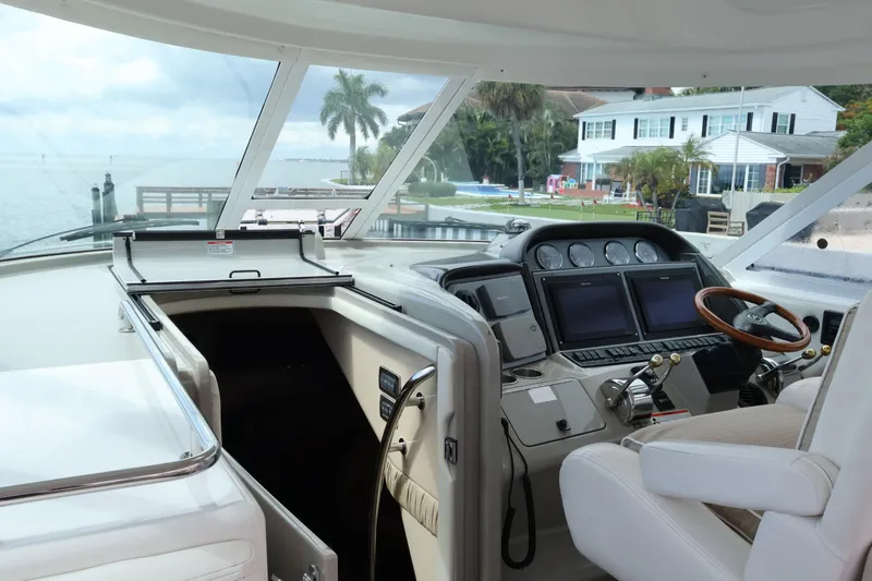 Slide: The Image of Interior view of 2006 Sea Ray 40 Motor Yacht cockpit with steering wheel and navigation screens. - 20