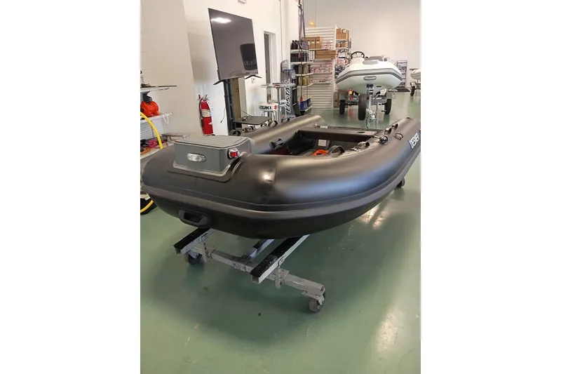 The Image of Desner 310 inflatable boat in showroom, 2026 model, on display with equipment. - 1