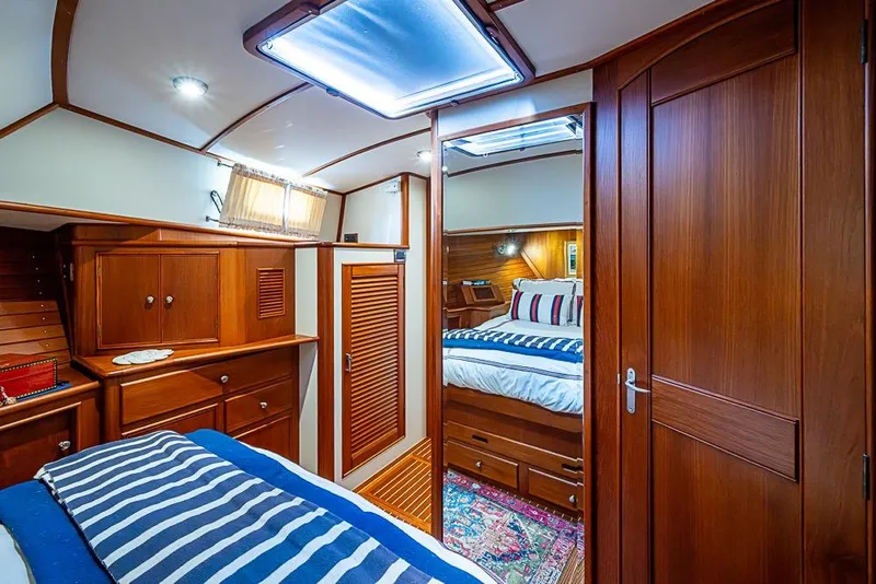 Slide: The Image of Luxurious 2001 Grand Banks 49 Eastbay HX yacht cabin with elegant wood interior. - 40