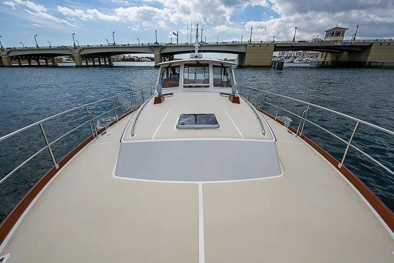 Slide: The Image of 2001 Grand Banks 49 Eastbay HX yacht cruising under a bridge on a sunny day. - 21