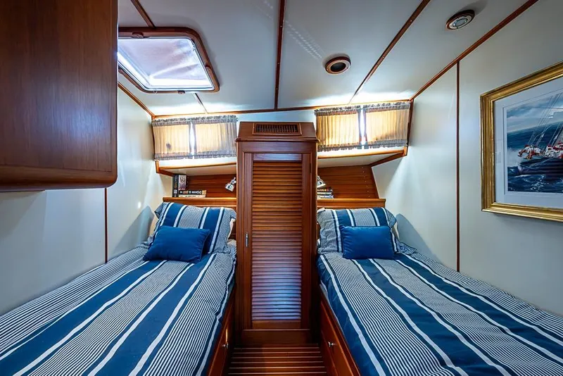 Slide: The Image of Luxurious 2001 Grand Banks 49 Eastbay HX cabin with twin beds and nautical decor. - 47