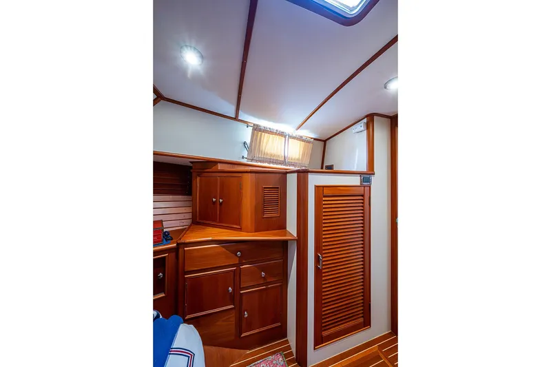 Slide: The Image of Interior of 2001 Grand Banks 49 Eastbay HX with wooden cabinetry and louvered door. - 44