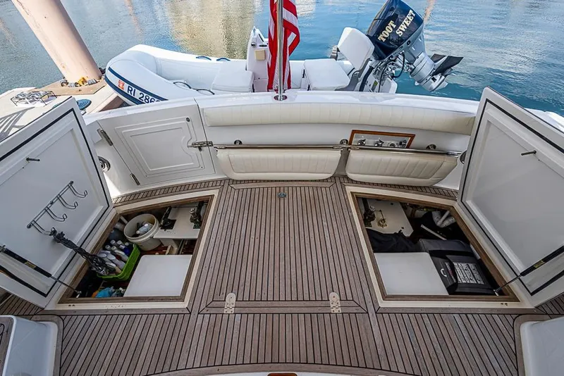 Slide: The Image of 2001 Grand Banks 49 Eastbay HX yacht deck with storage compartments and tender. - 15