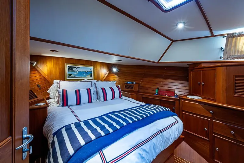 Slide: The Image of Luxurious cabin interior of 2001 Grand Banks 49 Eastbay HX yacht with wood paneling. - 42