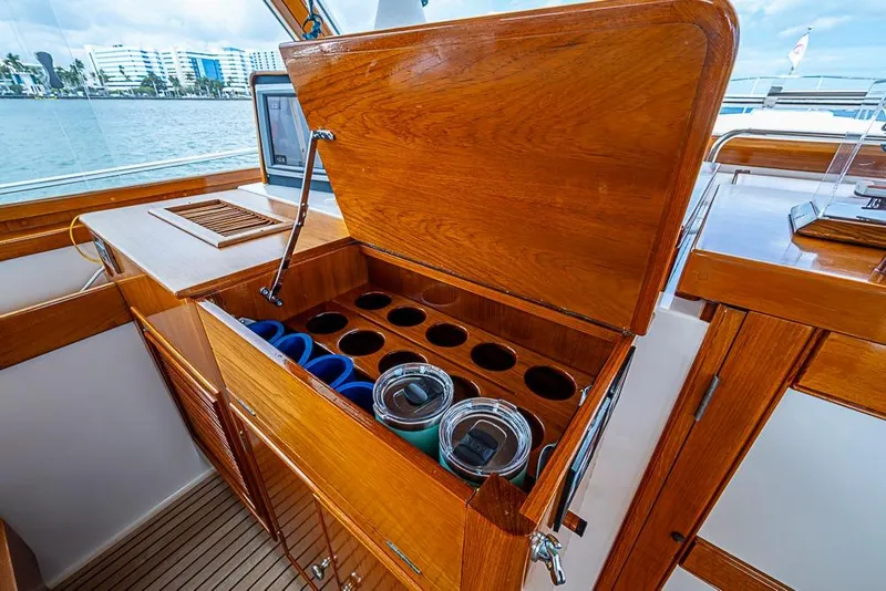 Slide: The Image of Luxurious 2001 Grand Banks 49 Eastbay HX yacht interior with wooden cabinetry and cup holders. - 28