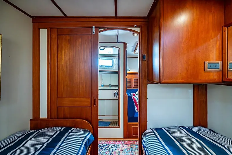 Slide: The Image of Interior of 2001 Grand Banks 49 Eastbay HX with wooden cabinetry and twin beds. - 48