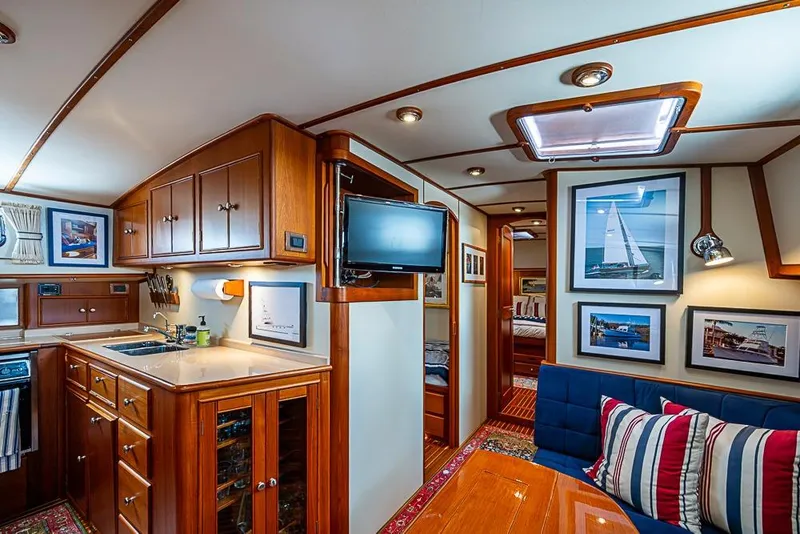 Slide: The Image of Luxurious 2001 Grand Banks 49 Eastbay HX yacht interior with elegant wood cabinetry and cozy seating. - 36