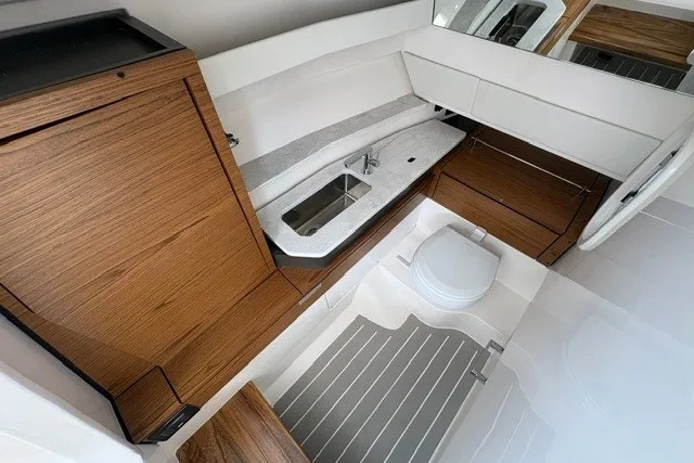Slide: The Image of Luxurious interior of 2027 Tiara Yachts 34 LX, featuring modern wood cabinetry and sleek fixtures. - 15