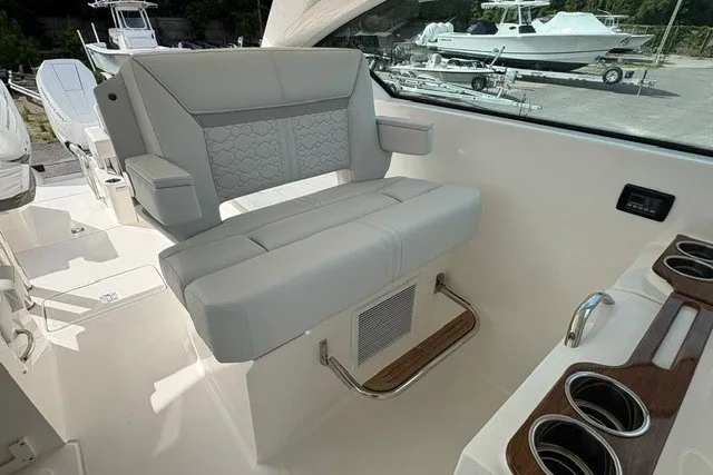 Slide: The Image of 2027 Tiara Yachts 34 LX interior seating with elegant design and cup holders. - 13