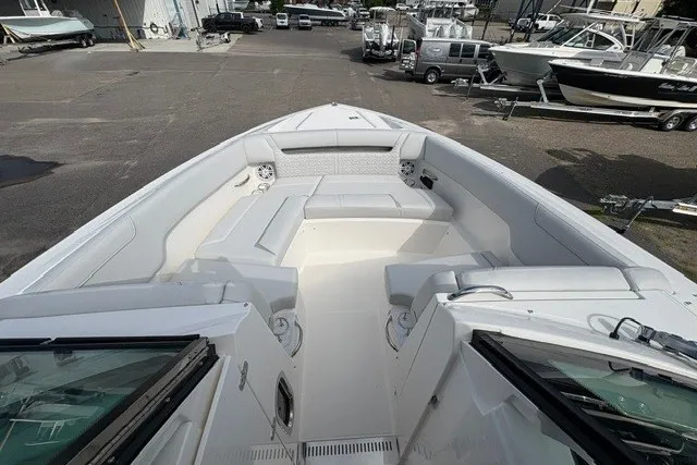 Slide: The Image of 2027 Tiara Yachts 34 LX boat with spacious seating area, docked in a marina. - 26