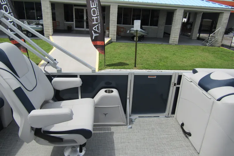 Slide: The Image of 2026 Tahoe Pontoon LTZ Versatile Rear Bench Wind Shield 23 interior with seating and cup holder. - 22