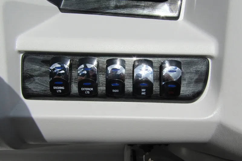 Slide: The Image of Control panel switches on 2026 Tahoe Pontoon LTZ Versatile Rear Bench Wind Shield. - 21