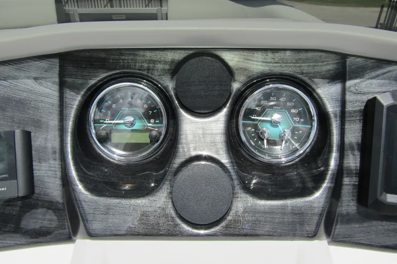 Slide: The Image of Dashboard of 2026 Tahoe Pontoon LTZ Versatile Rear Bench Wind Shield 23 with gauges. - 18