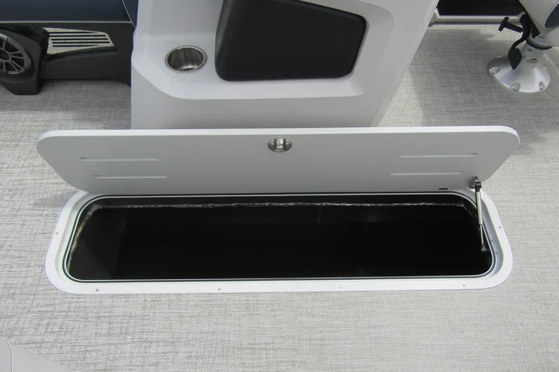 Slide: The Image of 2026 Tahoe Pontoon LTZ Versatile Rear Bench storage compartment, open on a sleek boat interior. - 14