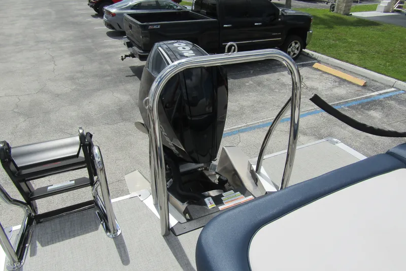 Slide: The Image of 2026 Tahoe Pontoon LTZ Versatile Rear Bench Wind Shield 23 with motor and ladder. - 30