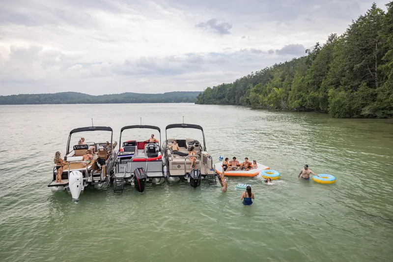 Slide: The Image of People enjoying a day on the lake with three 2026 Tahoe Pontoon LTZ boats. - 9