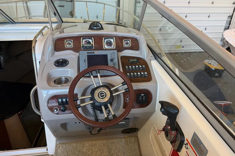 Slide: The Image of 2008 Chaparral Signature 270 boat dashboard with steering wheel and control panel. - 16