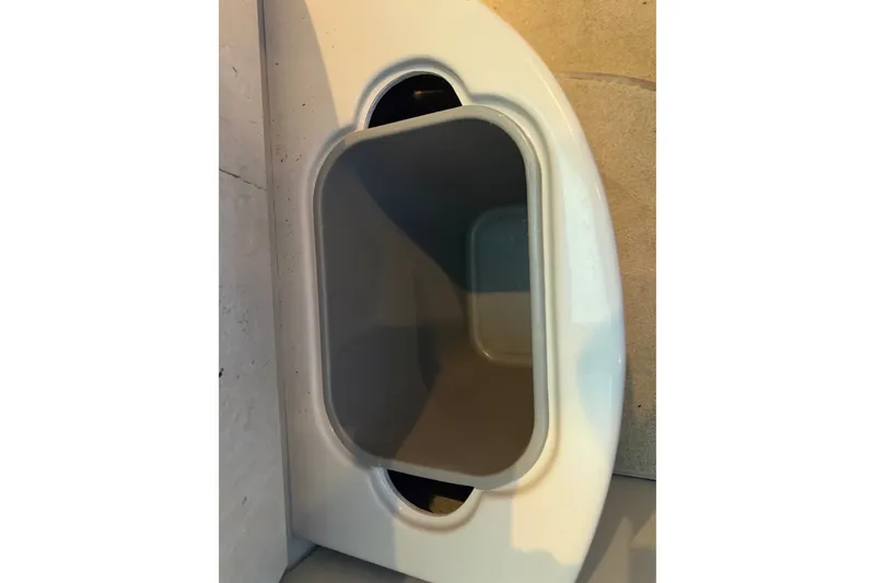 Slide: The Image of Storage compartment in 2008 Chaparral Signature 270 boat, featuring a sleek, white design. - 41