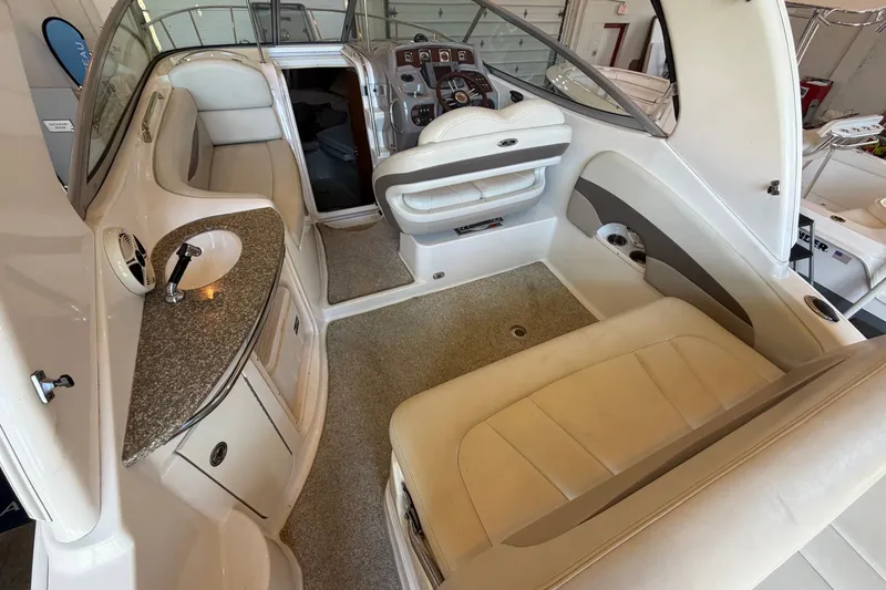 Slide: The Image of 2008 Chaparral Signature 270 boat interior with seating, steering wheel, and kitchenette area. - 14
