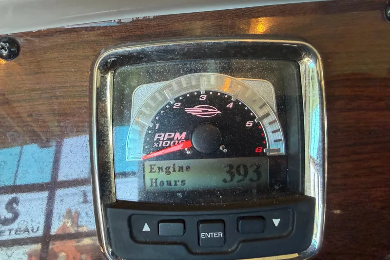 Slide: The Image of 2008 Chaparral Signature 270 dashboard showing RPM gauge and 393 engine hours. - 19