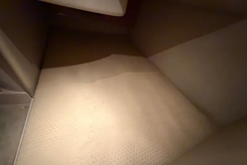 Slide: The Image of Interior cabin space of a 2008 Chaparral Signature 270 boat, featuring beige upholstery. - 30