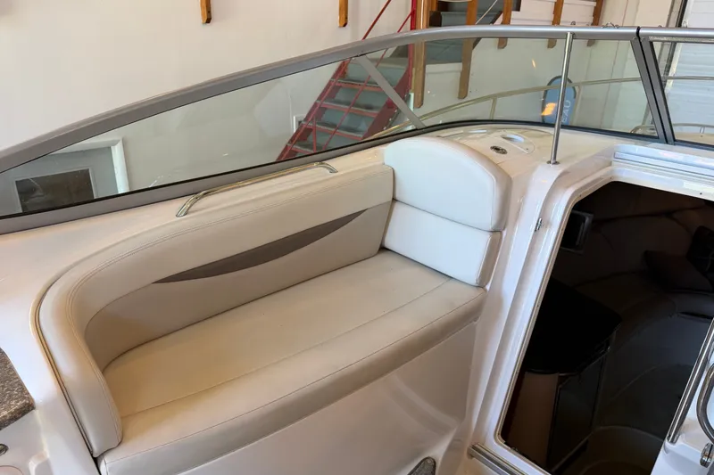 Slide: The Image of 2008 Chaparral Signature 270 boat interior with cushioned seating and cabin entrance. - 17