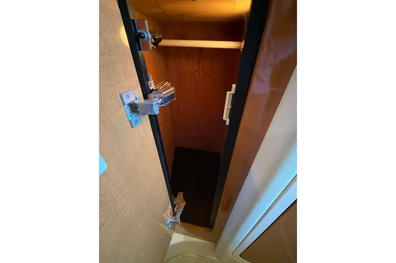 Slide: The Image of Open wooden cabinet inside 2008 Chaparral Signature 270 boat, showcasing interior storage space. - 38