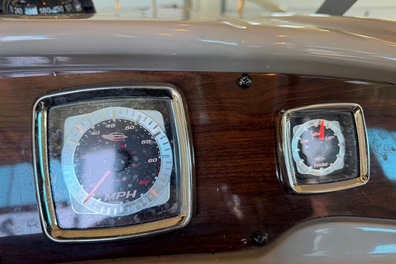 Slide: The Image of Dashboard of a 2008 Chaparral Signature 270 boat with speedometer and trim gauge. - 21