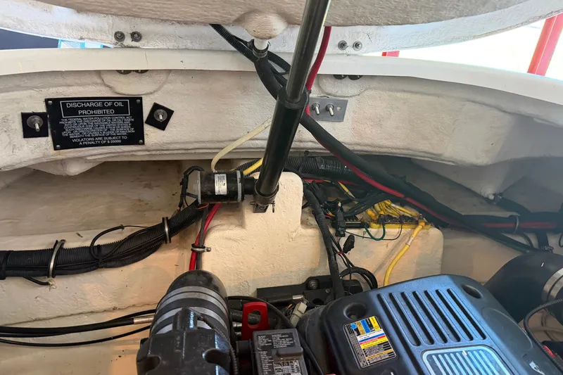 Slide: The Image of Engine compartment of 2008 Chaparral Signature 270 boat with wiring and oil discharge warning. - 25