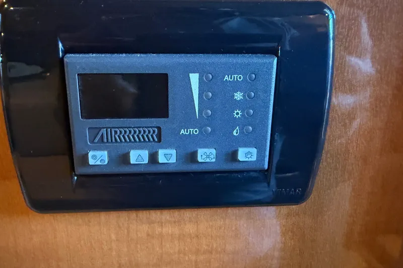 Slide: The Image of Control panel of a 2008 Chaparral Signature 270 boat, featuring climate settings. - 39