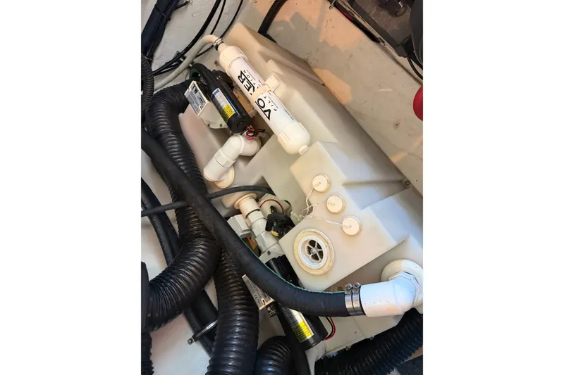 Slide: The Image of Engine compartment of a 2008 Chaparral Signature 270 boat, featuring hoses and components. - 24