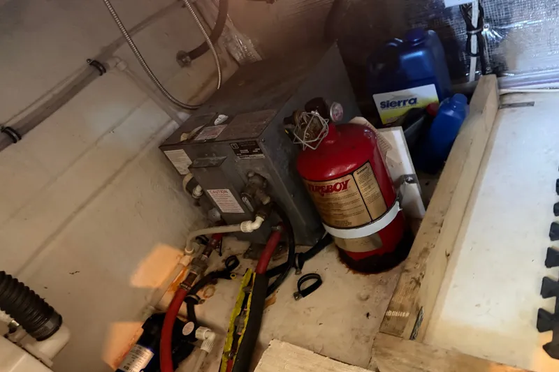 Slide: The Image of Engine compartment of a 2008 Chaparral Signature 270 with fire extinguisher and maintenance supplies. - 26
