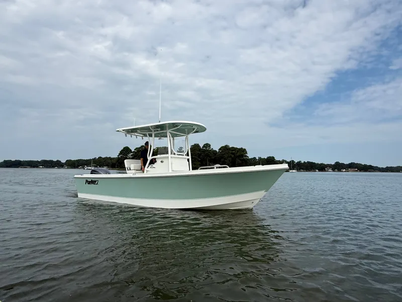 The Image of 2026 Parker 230 Coastal Elite on calm water with a cloudy sky in the background. - 0