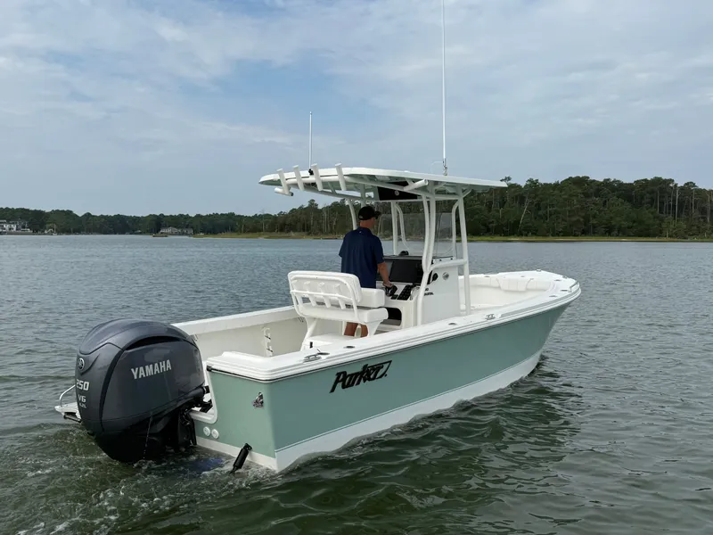 Slide: The Image of A 2026 Parker 230 Coastal Elite boat cruising on calm waters. - 5