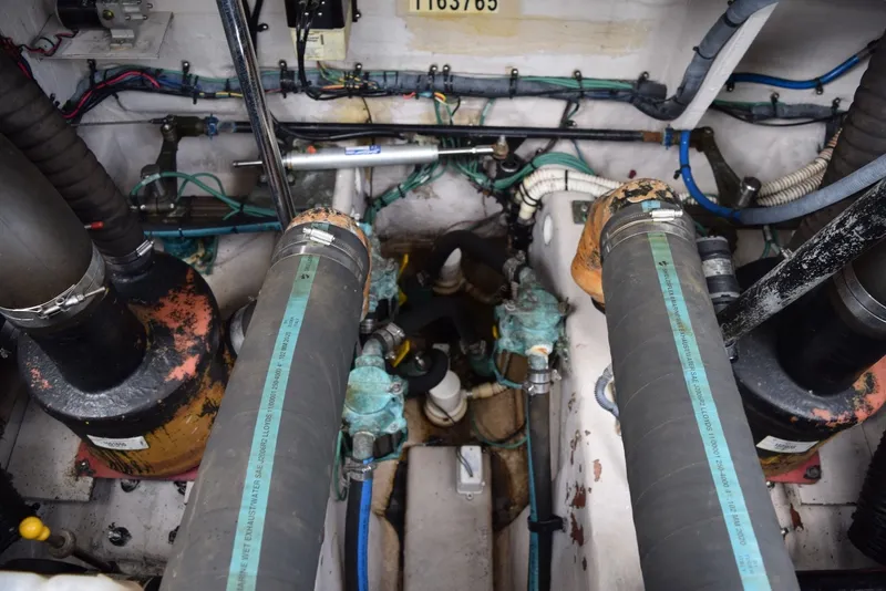 Slide: The Image of Engine room of a 2004 Sea Ray 390 Sundancer with visible hoses and wiring. - 38