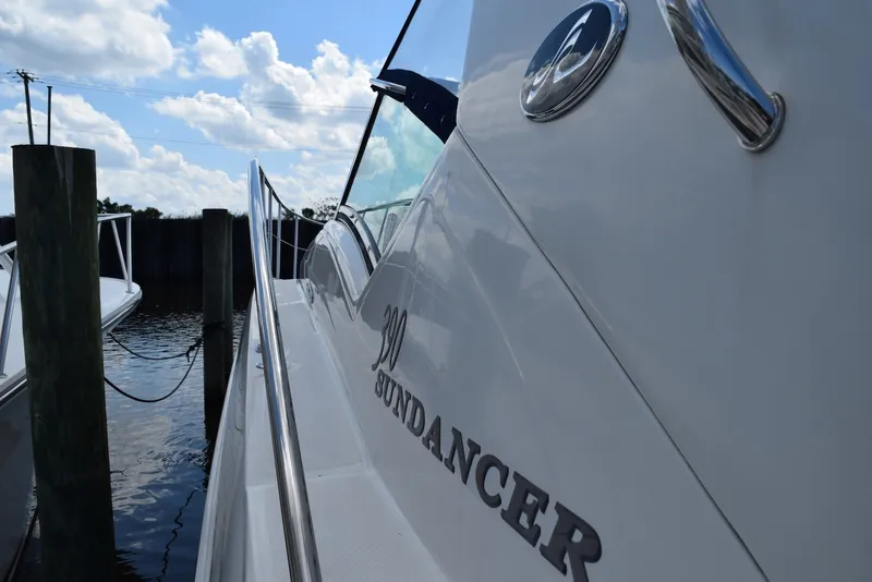 Slide: The Image of 2004 Sea Ray 390 Sundancer yacht docked under a blue sky. - 6