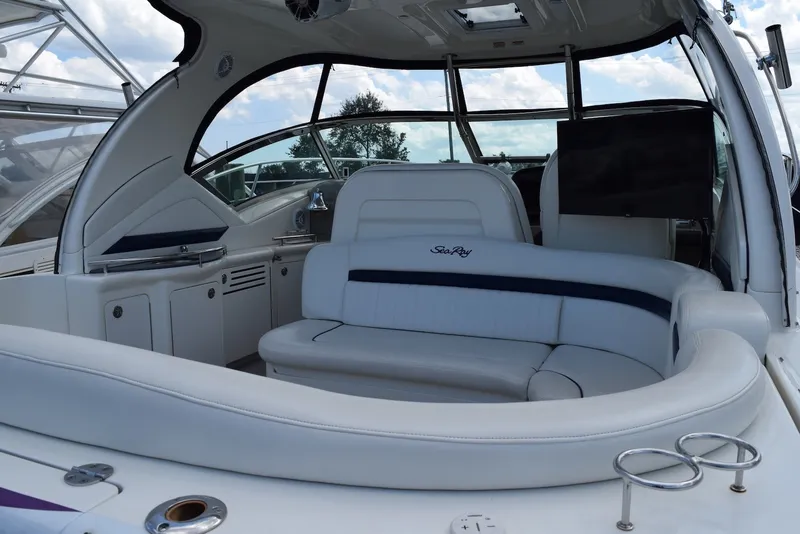 Slide: The Image of Interior of a 2004 Sea Ray 390 Sundancer yacht with white seating and modern amenities. - 3